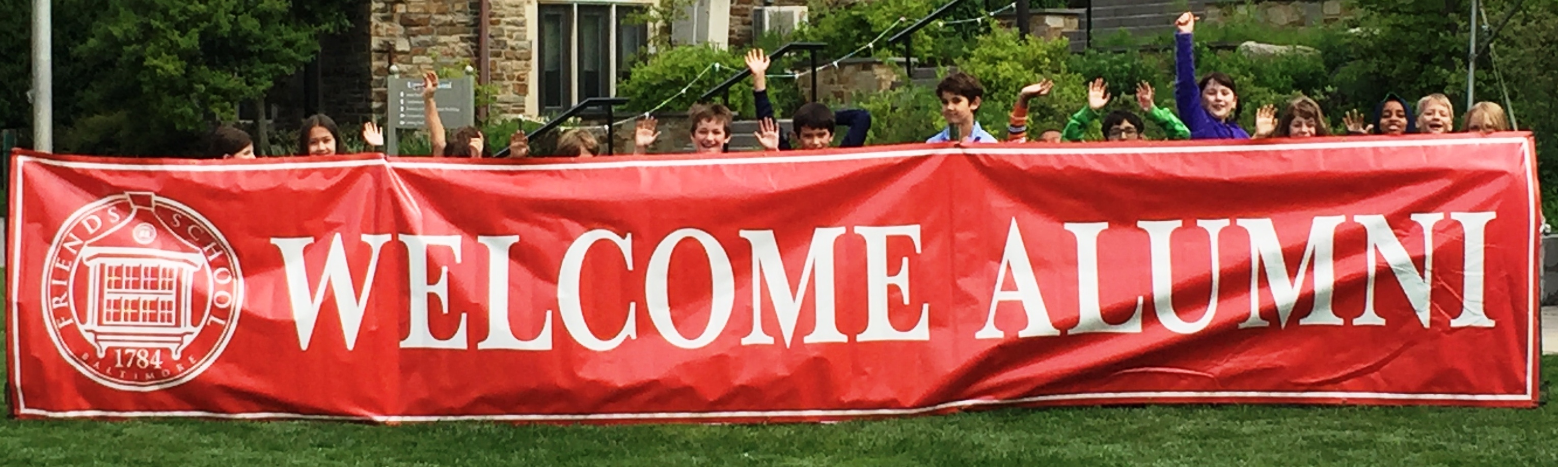 Welcome Alumni banner with kids